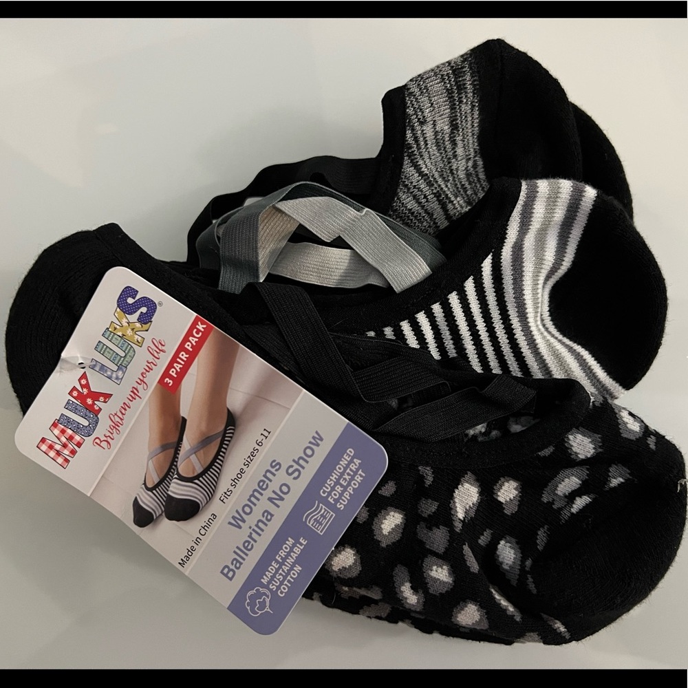 New with tags, two sets of ball babydoll Muk Luks socks.